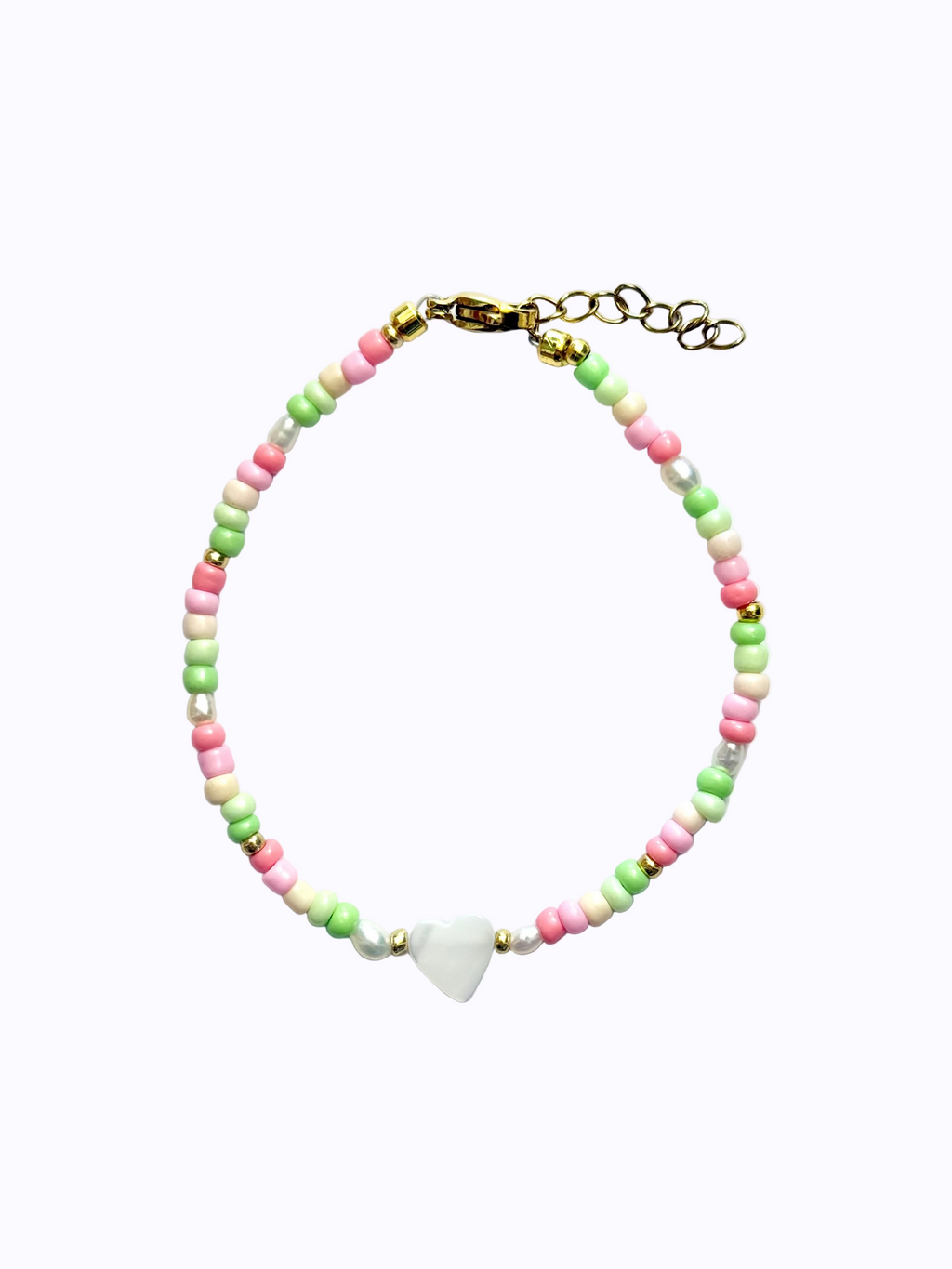 A heart-shaped mother of pearl bracelet colourful (pink, green and beige) beads on a white background.