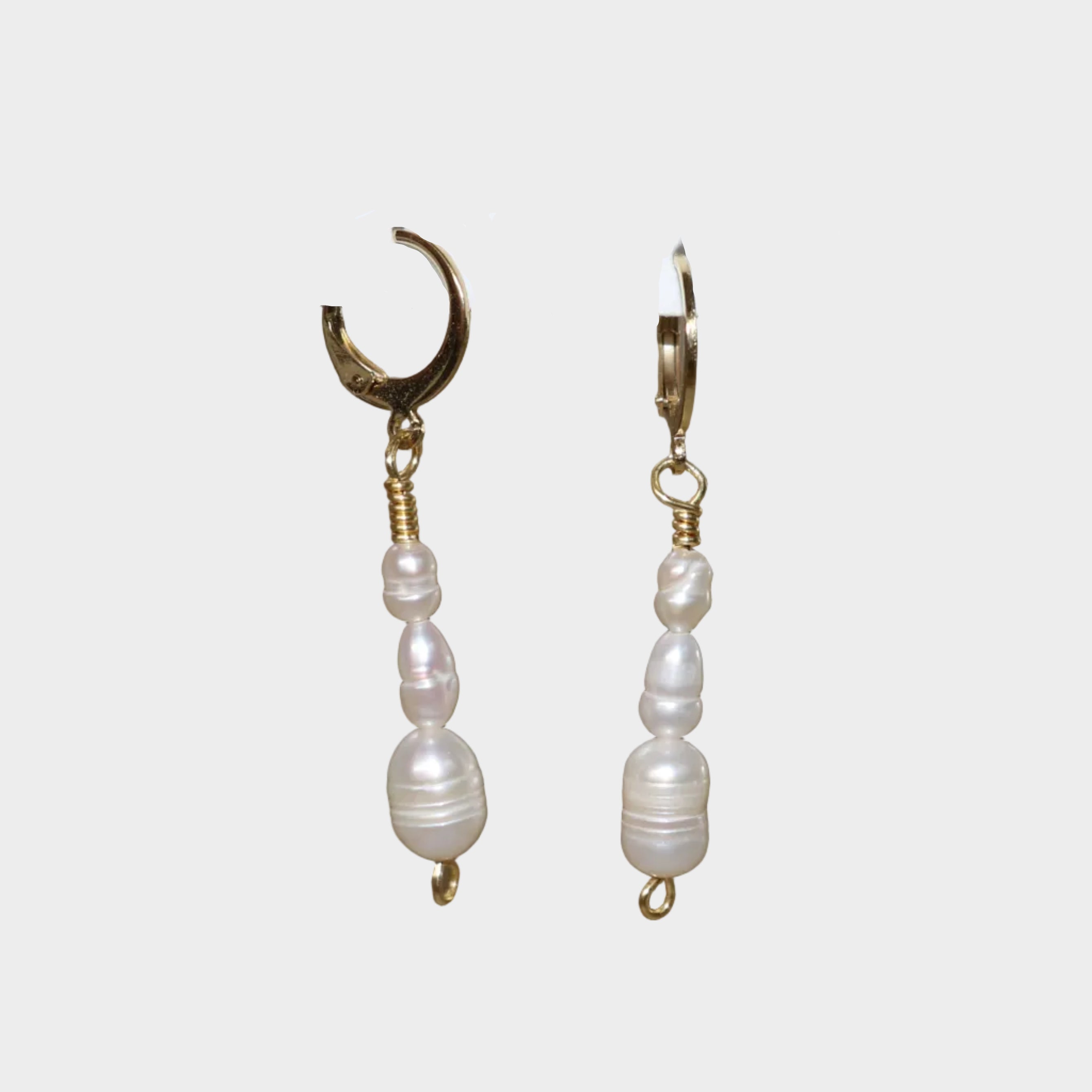 Cascade Pearl earrings in Gold with Lock designs, where three pearls get gradually bigger going down.