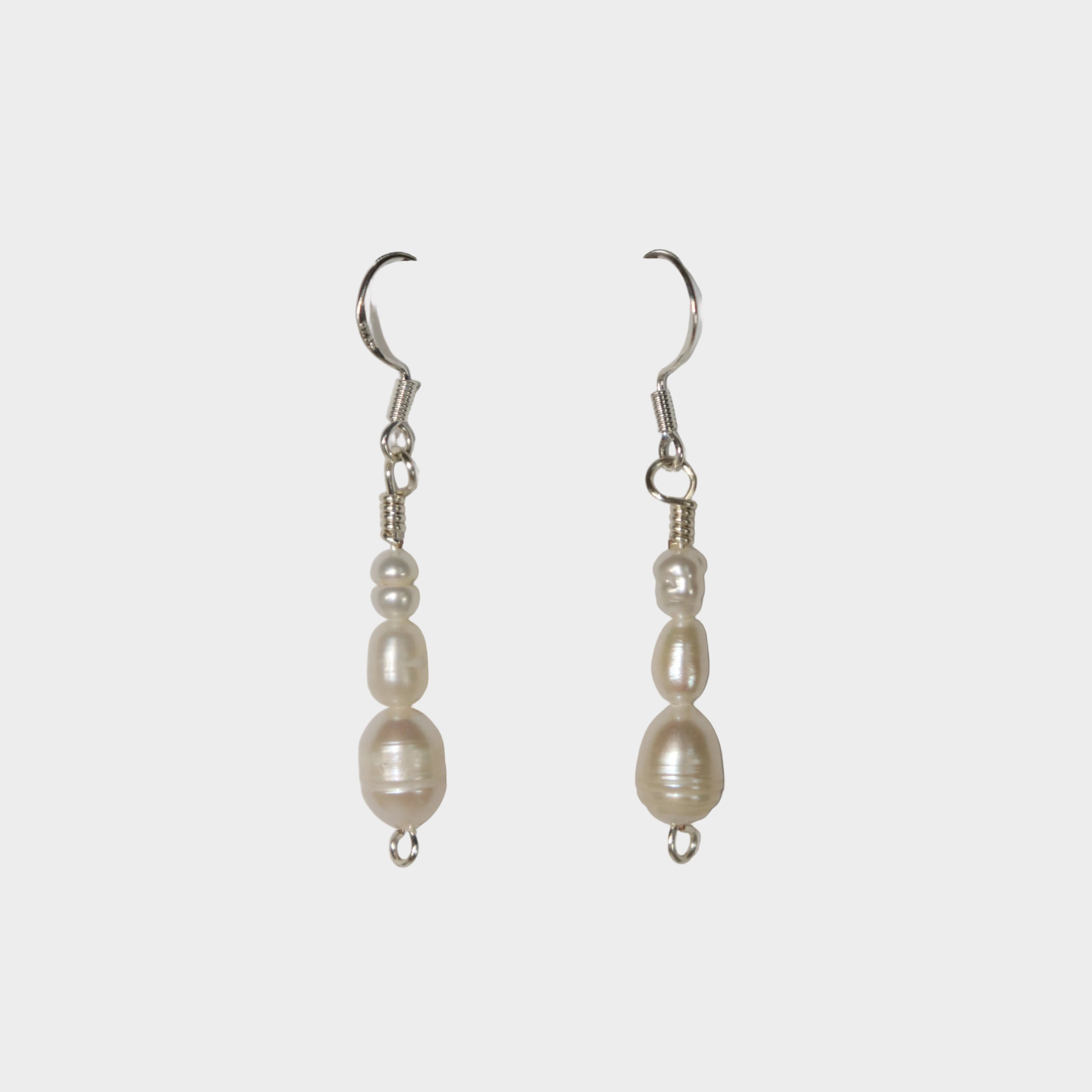 Pair of Cascade Silver pearl earrings on a light grey background