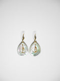 A gold earrings with teardrop-shaped mother of pearl with pearl in the middle on a white background.