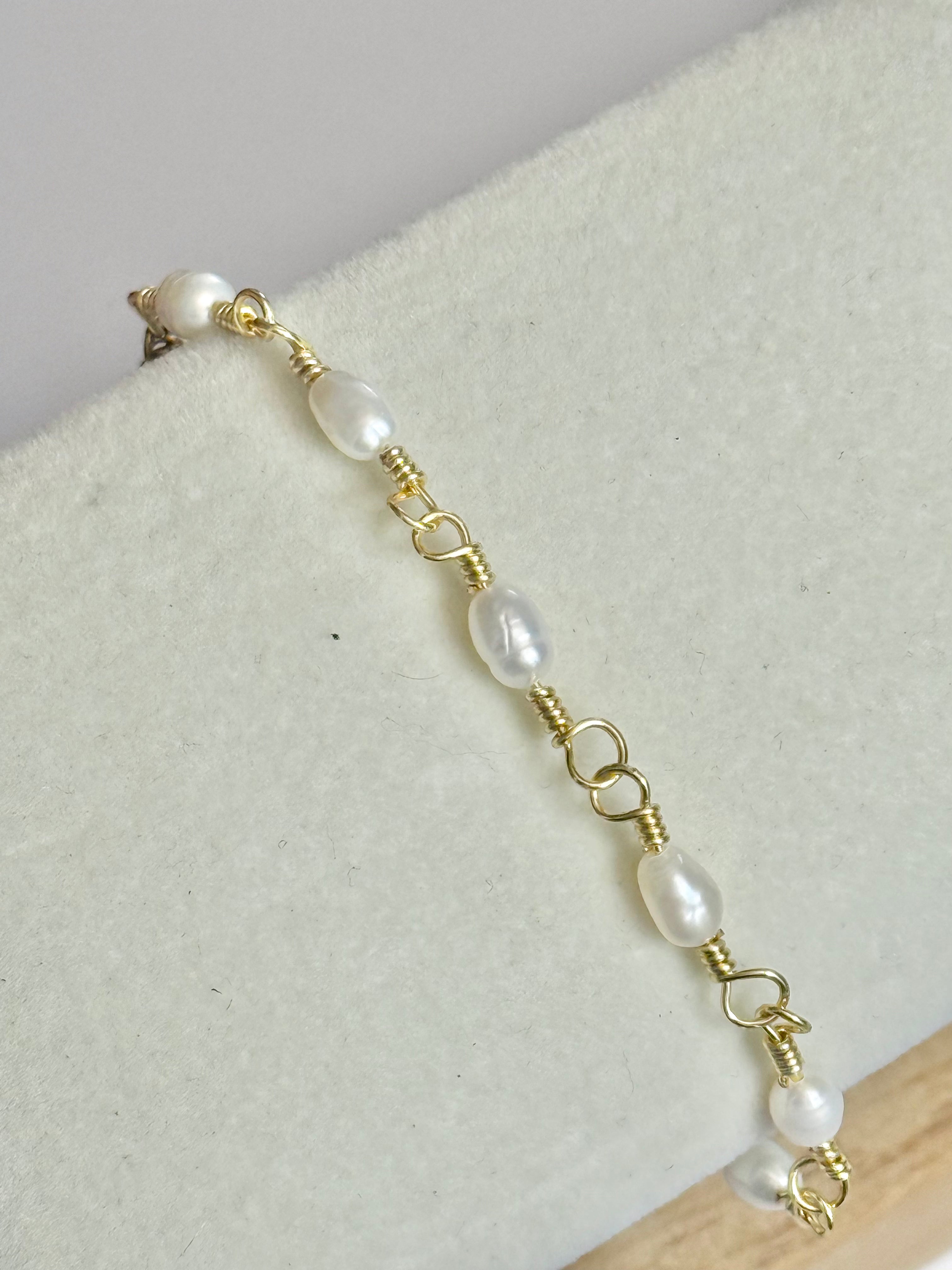 Close up shot of Gold Classic Pearl and Mother of Pearl Bracelet on display