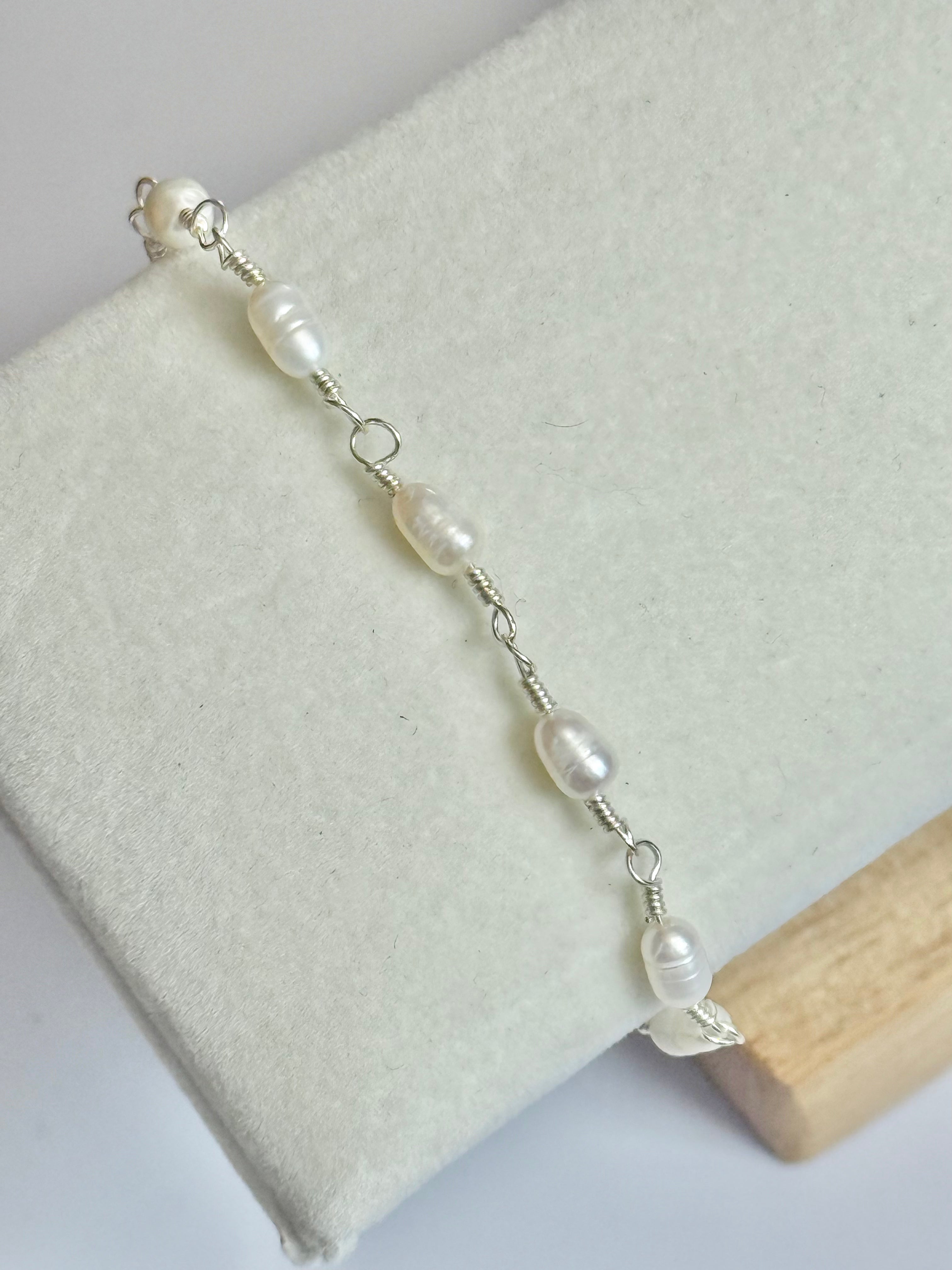 Close up of the Silver Classic Pearl and Mother of Pearl Bracelet on display.