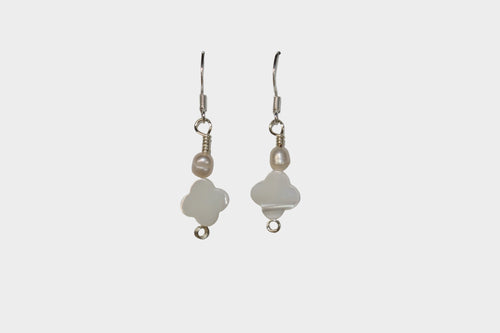 Clover mother of pearl and pearl earrings on a light grey background