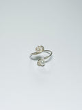 A silver pearl ring with a by-pass style body, creating an S-like body on a white background and shadow.