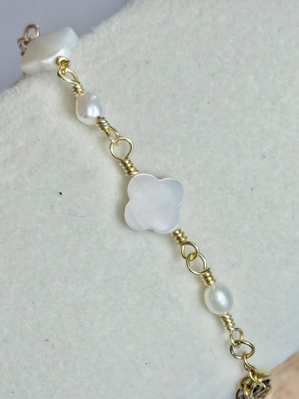 Close up of the Gold Clover Pearl and Mother of Pearl Bracelet on display.