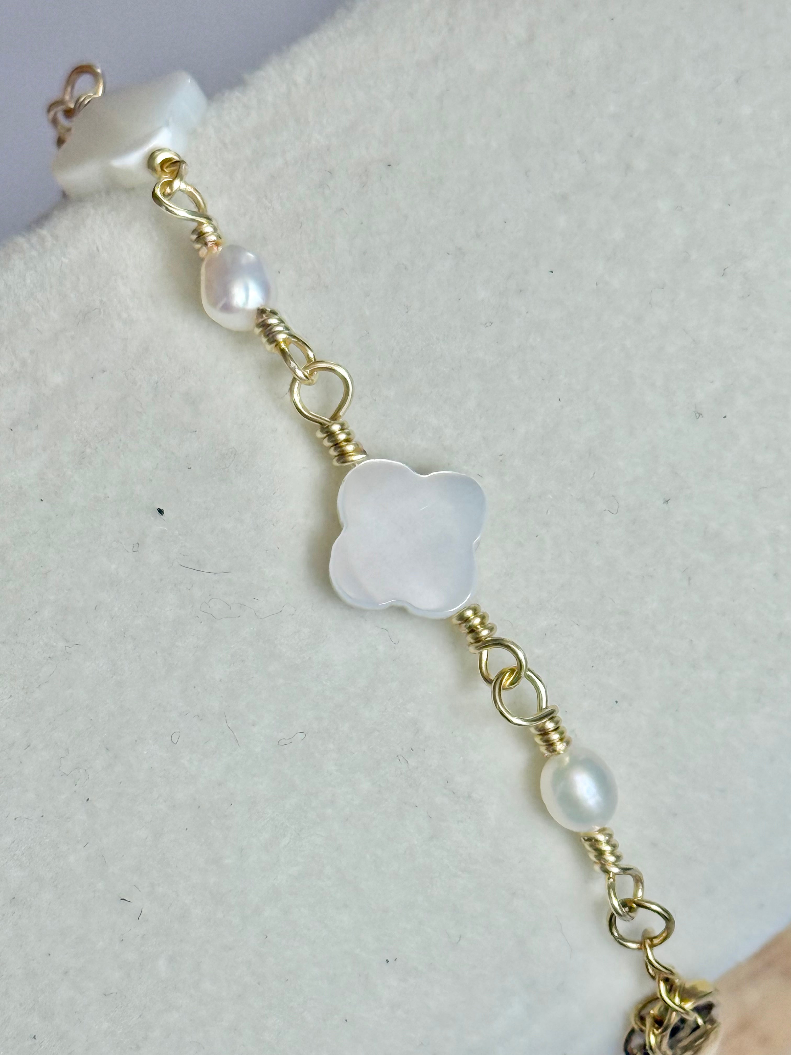 Close up of the Gold Clover Pearl and Mother of Pearl Bracelet on display.