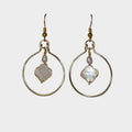 Gold hoop earrings with central stone on a light gray background