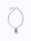 Bracelet with pearls on one half, pink, blue, and white beads on the other half, featuring jellyfish charm in the middle. On a white background.
