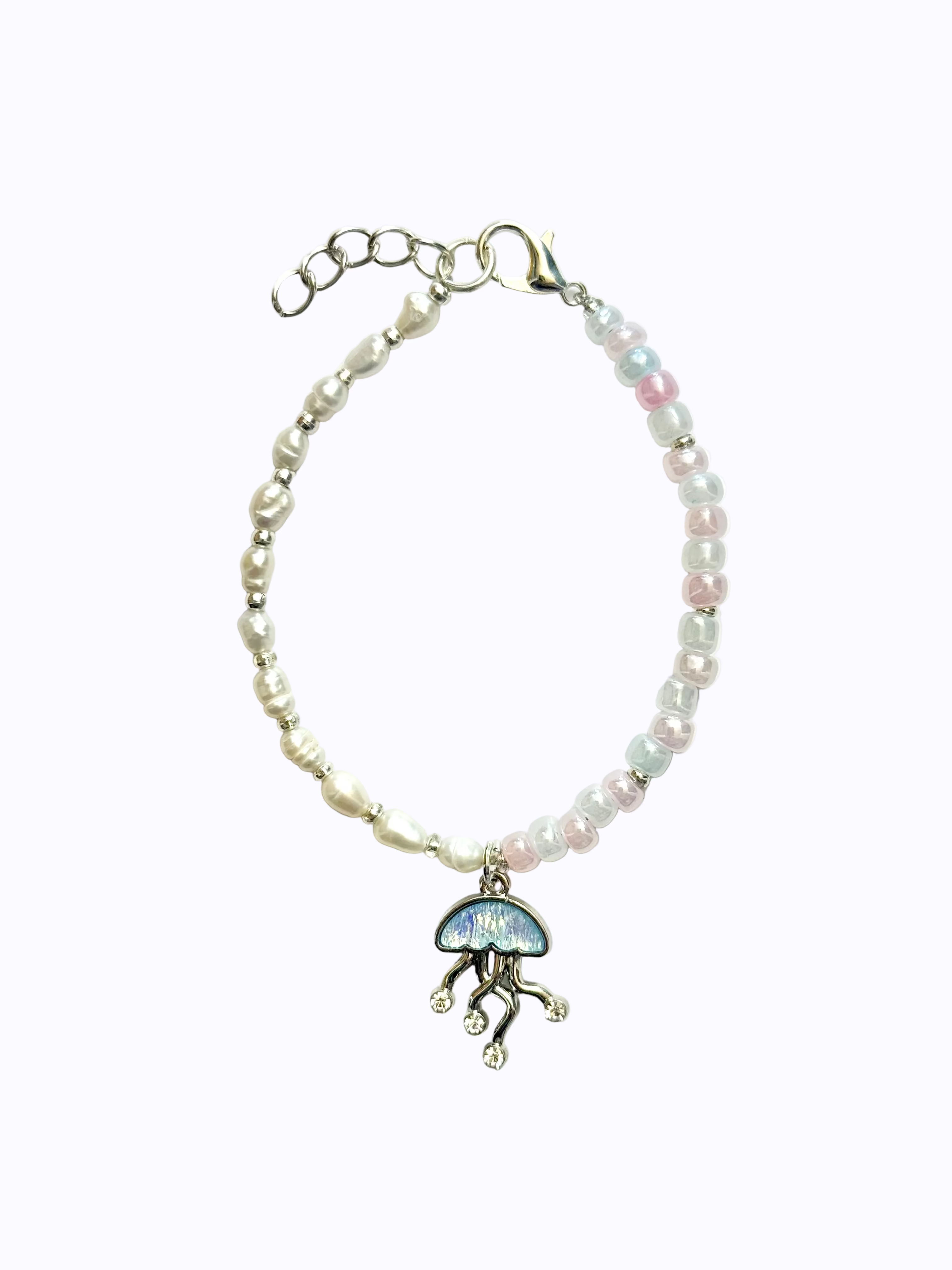 Bracelet with pearls on one half, pink, blue, and white beads on the other half, featuring jellyfish charm in the middle. On a white background.