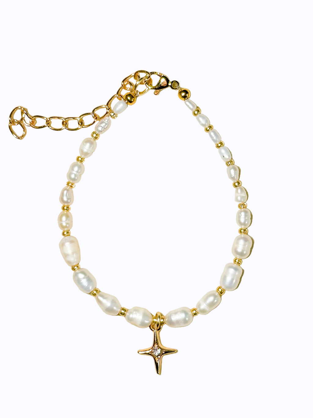 Premium Gold Pearl bracelet and star charm on a beige background