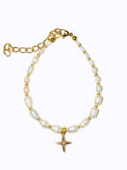 Premium Gold Pearl bracelet and star charm on a beige background