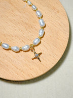 Premium pearl bracelet with a star-shaped pendant on a wooden board