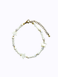 Gold Bracelet with star-shaped and cone-shaped pearls, round pearls and clear beads, on a white background.