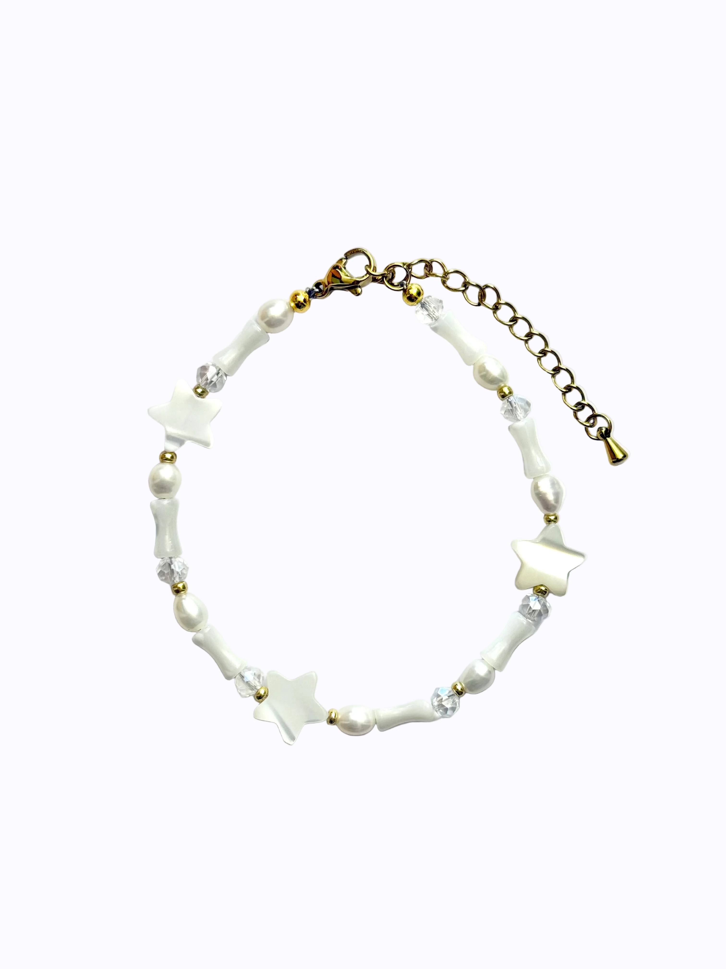Gold Bracelet with star-shaped and cone-shaped pearls, round pearls and clear beads, on a white background.