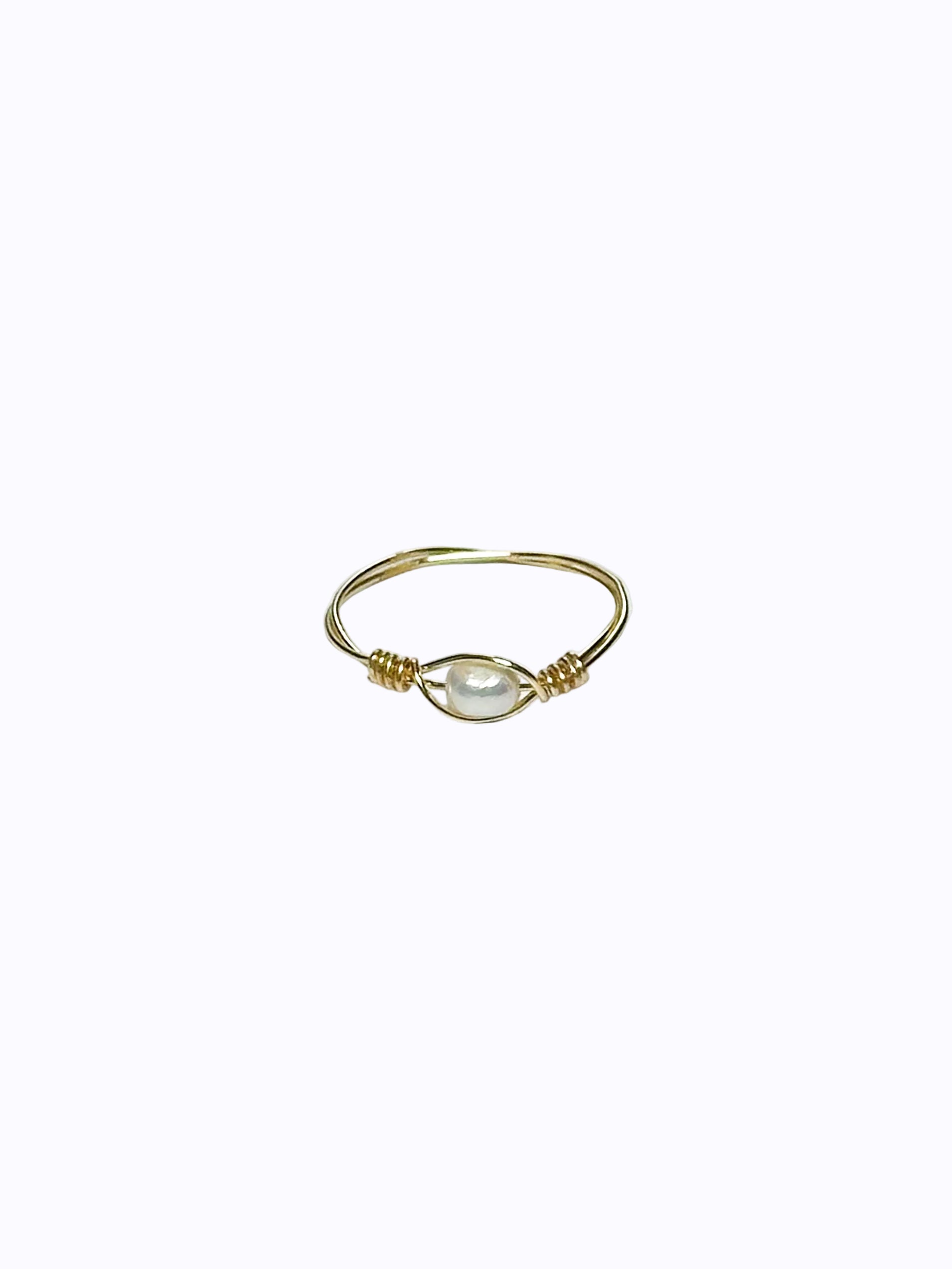 The Pearl Eye Gold wrapped ring on a white background.