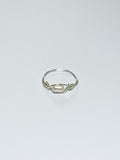 Silver ring with a pearl on a light gray background