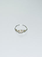 Silver ring with a pearl on a light gray background